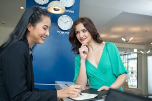 Receptionist demonstrating professionalism and communication skills at modern front desk